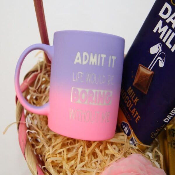 Gift basket with Cadbury Dairy Milk chocolate bars, pastel mug, and rose-scented candle